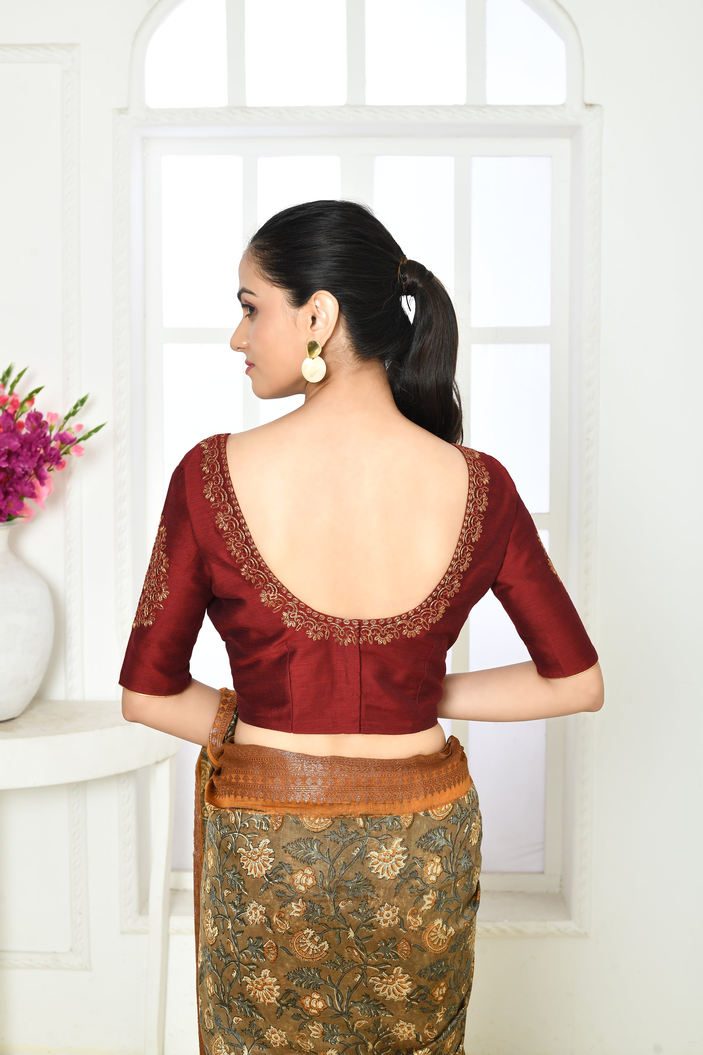 Dark maroon pure raw silk elbow length blouse with golden floral embroidery in sleeves, front and back neck.