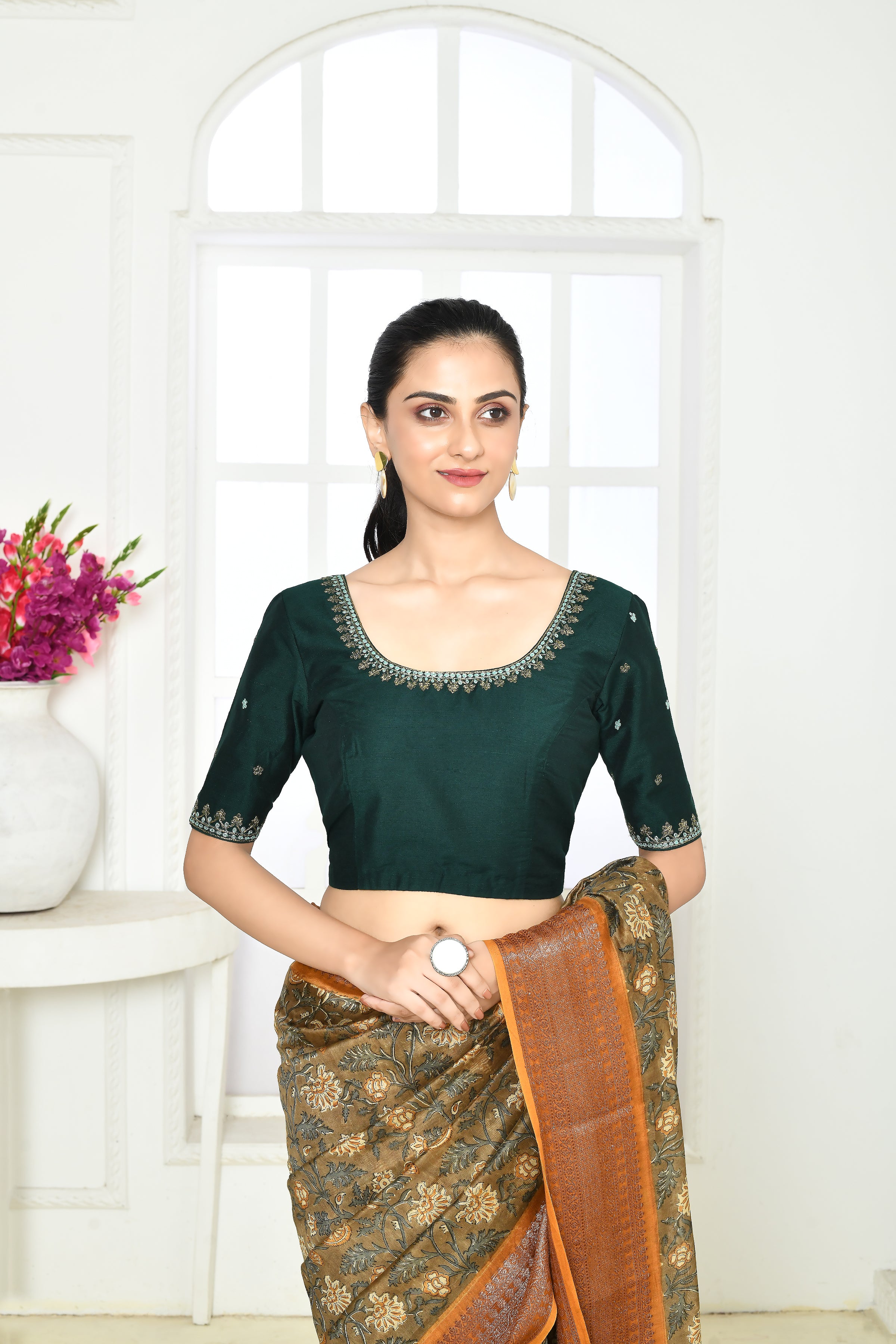 Bottle green pure raw silk elbow length blouse with golden floral embroidery in sleeves, front and back neck.
