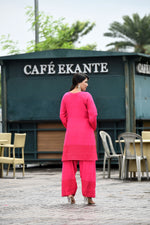 Vibrant fuschia pink flared sleeves mid thigh length straight kurta and farshi salwar set with cut work embroidery